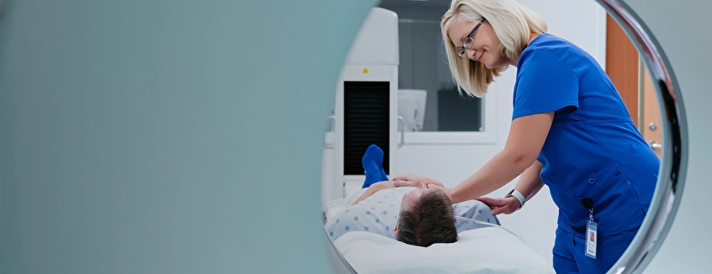 A patient is about to be put through a computed tomography machine.